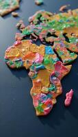 Microplastics polluting the globe portrayed as colored debris shaping world map photo
