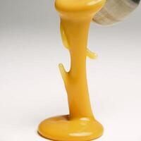 Molten cheddar creates an isolated form through dripping and splattering photo