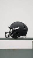 Minimalistic stock photo Closeup of a football helmet on a bench featuring simplified forms and contrasting colors leaving ample room for text insertion