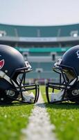 Two American Football Helmets facing off against one another atop a gridiron within a Stadium setting photo