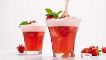 Vibrant red strawberry soda served in a margarita glass with floating mint leaves photo