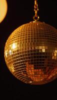 A golden disco ball adds an elegant shimmery radiance to party settings photo