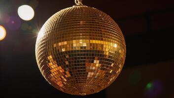 A golden disco ball adds an elegant shimmery radiance to party settings photo