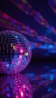 A disco ball shines against an abstract backdrop of colored rays and light effects Purple Pink Blue photo