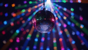Vibrant mirrorball spins casting a kaleidoscopic glow at a lively party scene photo
