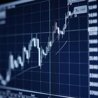 Financial chartsprofit graphs showing business stock market trends analyzed using candlestick graphs against a dark blue backdrop photo
