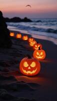 Glowing jackolanterns illuminate eerie beach at twilight Halloween photo