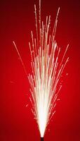 Fireworks illuminate against a striking red backdrop photo