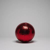 Isolated red disco ball glows against blank canvas backdrop photo