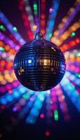 Disco ball glowing against backdrop of colorful reflected light rays photo