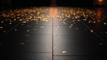 A luxurious black dance floor glitters with golden confetti photo
