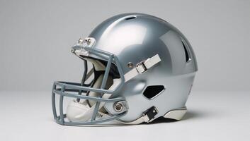 Highangle view Shiny silver football helmet with facemask and white pads photo