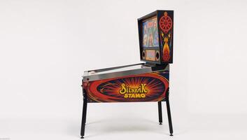 Vintage pinball machine with vibrant colors set against a clean white backdrop photo