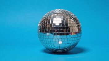 A vibrant disco ball illuminates a lively festive scene with its sparkles against a backdrop of deep blues photo
