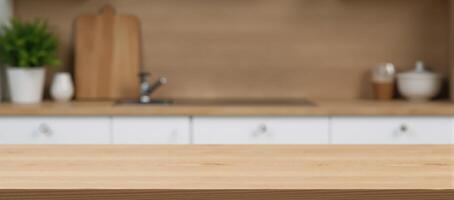Modern kitchen interior with an empty beautiful wooden tabletop and bokeh backdrop ready for product montage photo