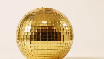 A shimmering gold disco ball against a crisp white backdrop photo