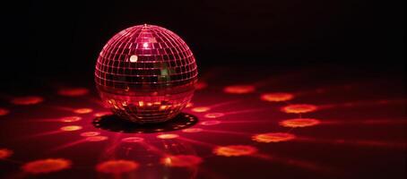 A shimmering red disco ball reflects light against an empty backdrop symbolizing a festive and lively atmosphere photo