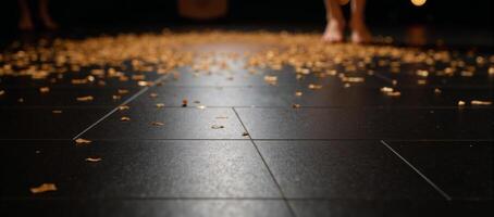 A luxurious black dance floor glitters with golden confetti photo