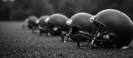Worn football helmets on rainsoaked field with bokeh light effects photo