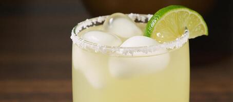 Classic margarita featuring lime wedge and ice cubes photo