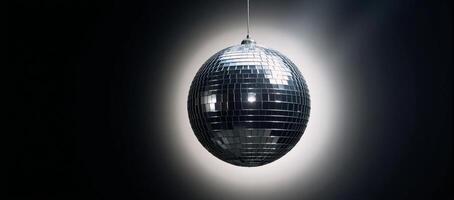 Glossy disco ball against a solid black backdrop photo