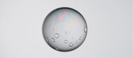 Closeup photograph featuring a water bubble sphere against a plain white background photo