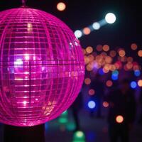 A closeup image featuring a lively disco scene against a backdrop of vibrant neon lights and a sparkling pink disco ball photo