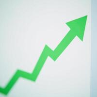 A green businessrelated line graph on an arrows background file format photo