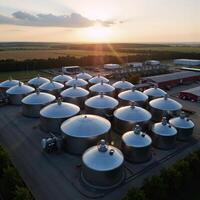 A summer evening industrial scene features a chemical factory with large pressurized hydrogen storage tanks and BPVC manufacturing facilities amidst the sprawling terrain of industrial ASME tanks photo