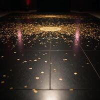 A luxurious black dance floor glitters with golden confetti photo