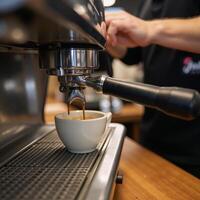 Barista preparing aromatic espresso at caf restaurant photo