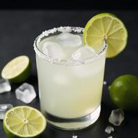 Cocktail Margarita served with ice and limes in a saltrimmed margarita glass Refreshing photo