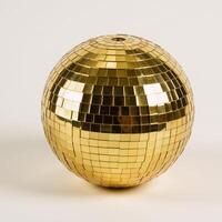 A shimmering gold disco ball against a crisp white backdrop photo