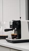 A stylish modern espresso machine serves up freshly brewed shots photo