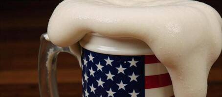 An Americanflagged beer mug overflowing with frothy head photo