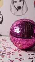 Pink disco ball adorned with colorful squares amidst a shower of sparks and confetti within an illustrative scene photo