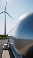 Closeup image of an industrial hydrogen fuel tank amidst a backdrop of a hydrogen power plant signifying progress towards achieving net zero emissions by 2050 photo