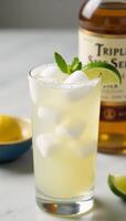 Classic margarita featuring lime wedge and ice cubes photo