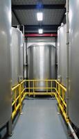 A futuristic interior view of a hydrogen production and processing plant featuring large storage tanks connected by intricate piping systems for H2 manufacturing visualization photo
