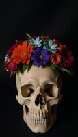 Skull decorated with colorful flowers amidst a black backdrop redorange roses bluegreen foliage photo