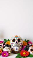 Traditional Mexican Day of the Dead decoration featuring sugar skulls floral arrangements and leafy elements in a celebratory setting with an empty space for personalization photo