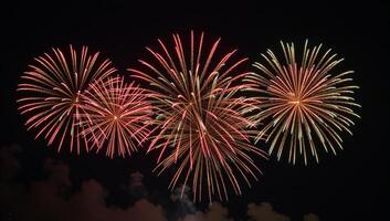 Fireworks illuminate a dark night sky photo
