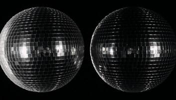 A minimalist scene features disco ball patterns with highcontrast silver black and gray textures against a dark backdrop photo
