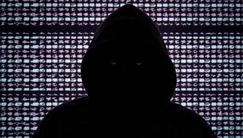 Hacker in hood against glitchy computer code backdrop Glitch Art Style photo