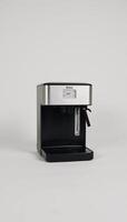 Black coffee maker machine with an icon is depicted against a white background isolated photo