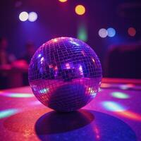 A glittering purple disco ball surrounded by colorful disco lights photo