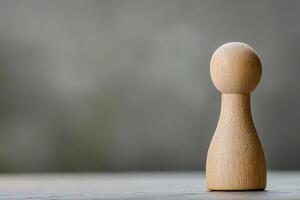 A wooden figure stands on a table photo