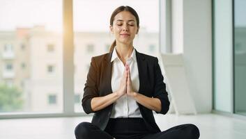 Portrait of an adult businesswoman meditating with closed eyes and Namaste pose in natural light against blurry orbs photo