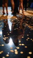 A luxuriant black dance floor sparkles with golden confetti photo