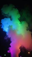 Vivid light show featuring colored smoke against a dark backdrop at night photo